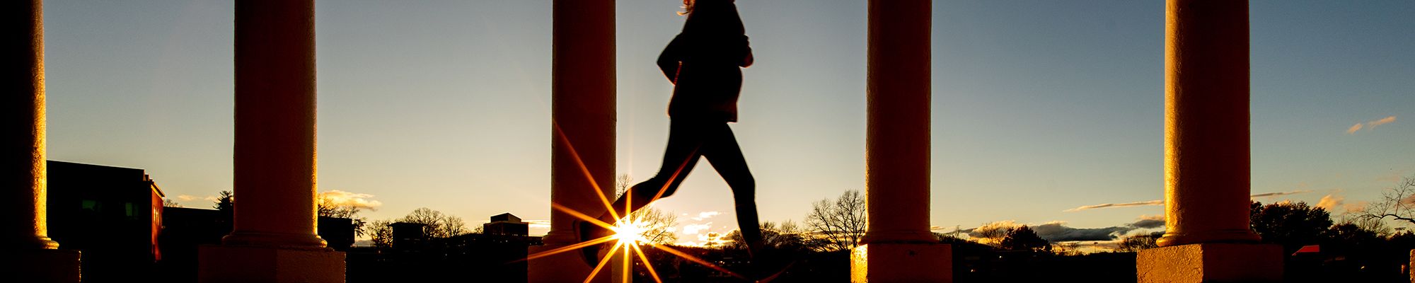 girl running on grounds at sunrise